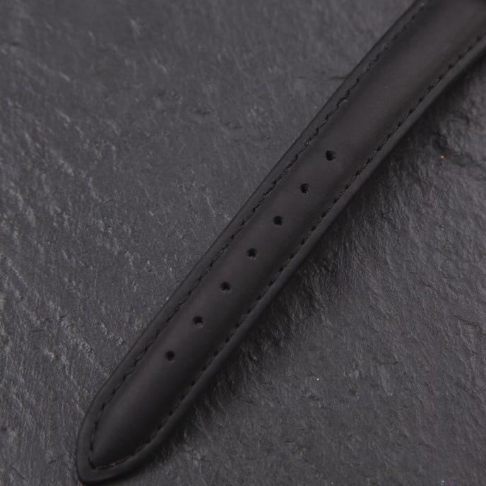 Teilansicht eines schwarzen Uhrenarmbands, minimalistisches Design.